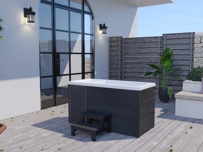 Compact outdoor hot tub on modern patio with fence, steps, lanterns